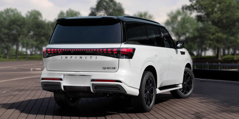 A white Infiniti QX80 SUV viewed from the rear, showcasing its sleek design and distinctive tail lights.